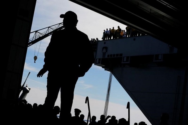 US President Donald Trump takes the stage in the flight hangar to deliver remarks aboard the pre-commissioned US Navy aircraft carrier Gerald R. Ford at Huntington Ingalls Newport News Shipbuilding facilities in Newport News, Virginia, US March 2, 2017. PHOTO: REUTERS