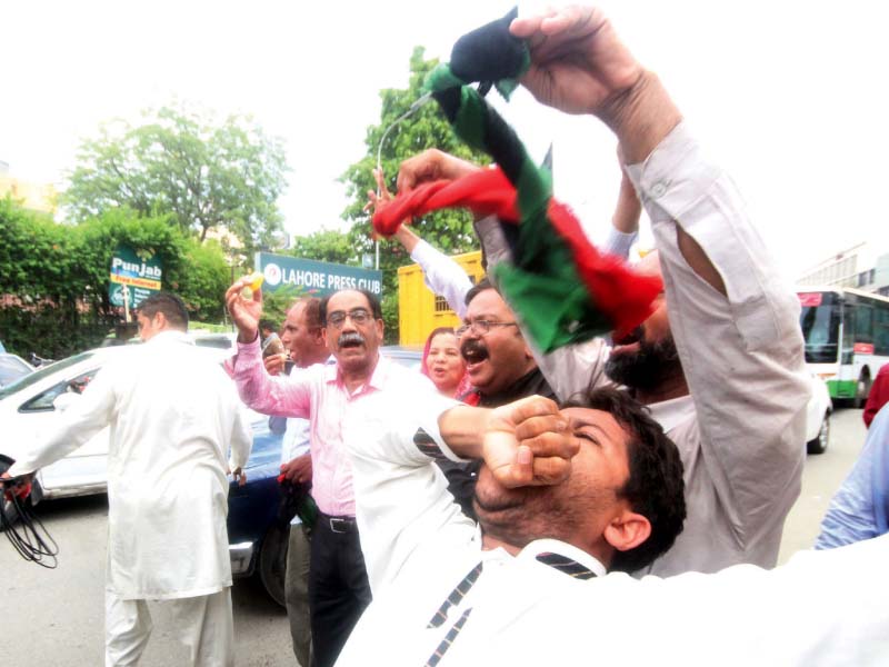A man celebrates the Panamagate verdict outside the Lahore Press Club. PHOTO: EXPRESS
