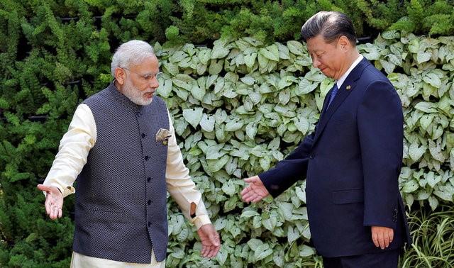 Indian Prime Minister Narendra Modi (L) and Chinese President Xi Jinping leave after a group picture during BRICS (Brazil, Russia, India, China and South Africa) Summit in Benaulim, in the western state of Goa, India. PHOTO: REUTERS