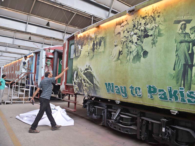 Pakistan Railways employees walk past Azadi Train. PHOTO: AFP