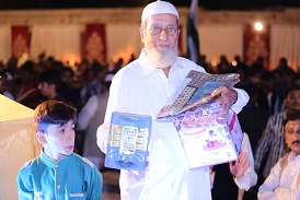An elderly man struggles to hold on to the prizes he won during MTMA's recent annual event. PHOTO: COURTESY MTMA