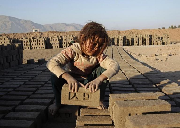 An Afghan girl works at a brick-making factory in Nangarhar province. PHOTO: REUTERS