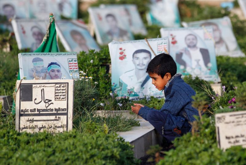 A Yemeni child sits next to the grave of a loved one in the rebel-held capital Sanaa on September 1, 2017, among more than 8,000 people who have been killed since a Saud-led coalition intervened to prop up the beleaguered government in March 2015. PHOTO: AFP