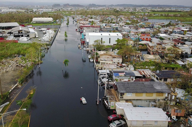 An aerial view shows the flooded neighbourhood of Juana Matos in the aftermath of Hurricane Maria in Catano, Puerto Rico, on September 22, 2017. Puerto Rico battled dangerous floods Friday after Hurricane Maria ravaged the island, as rescuers raced against time to reach residents trapped in their homes and the death toll climbed to 33. Puerto Rico Governor Ricardo Rossello called Maria the most devastating storm in a century after it destroyed the US territory's electricity and telecommunications infrastructure. PHOTO: AFP.