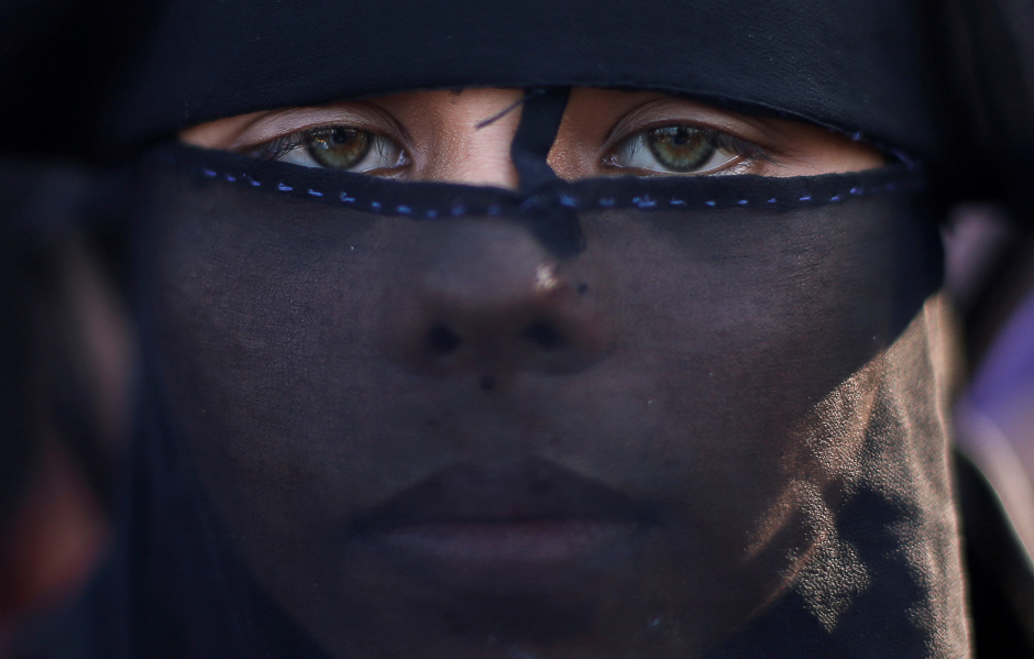 Sanuara Begum, 13, a Rohingya refugee, waits to receive permission from the Bangladeshi army to continue her way after crossing the Bangladesh-Myanmar border, at a port in Teknaf, Bangladesh. PHOTO: REUTERS