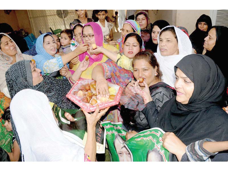 PML-N workers celebrating re-election of Nawaz Sharif. PHOTO: EXPRESS