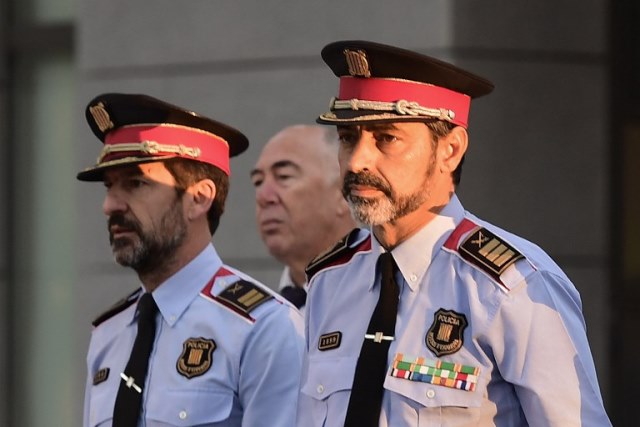 Josep Luis Trapero (R), chief of the Catalan police Mossos d'Esquadra who is under investigation for sedition, arrives to the High Court in Madrid on October 6, 2017. 
Spain's government has defiantly rejected calls for mediation over Catalonia's push for independence as the two factions headed towards another showdown. The courts placed Catalonia's regional police chief Trapero and three other suspects under investigation for an alleged "crime of sedition". PHOTO: AFP
