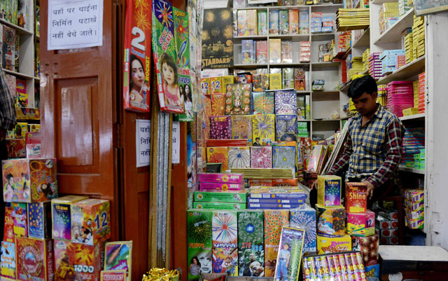 An Indian shopkeeper waits for customers at his firecracker shop in New Delhi on October 9, 2017. PHOTO: AFP