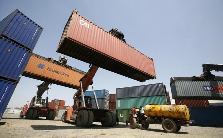 Mobile cranes prepare to stack containers port. PHOTO: REUTERS
