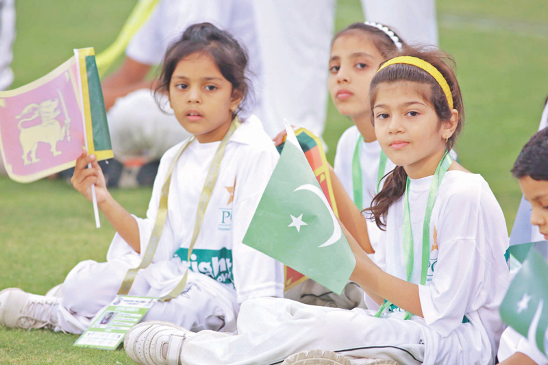 Children wave flags of Pakistan and Sri Lanka during the final T20 match. PHOTO: MALIK SHAFIQ/EXPRESS