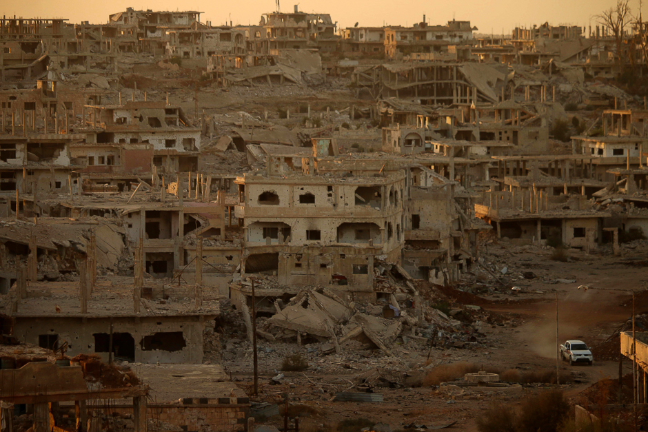 A truck drives through a damaged street in a rebel-held area of the southern Syrian city of Daraa. PHOTO: AFP