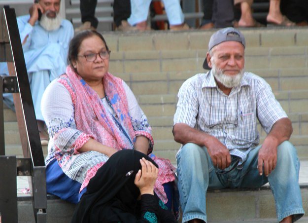 Aged people sitting on the stairs waiting for their turn at a biometric verification centre. PHOTO: ATHAR KHAN