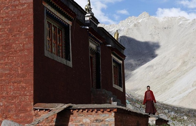 File Photo: A Tibetan monk stands outside a temple near Mount Kailash in Ngari, Tibet Autonomous Region September 3, 2011. 
PHOTO: REUTERS