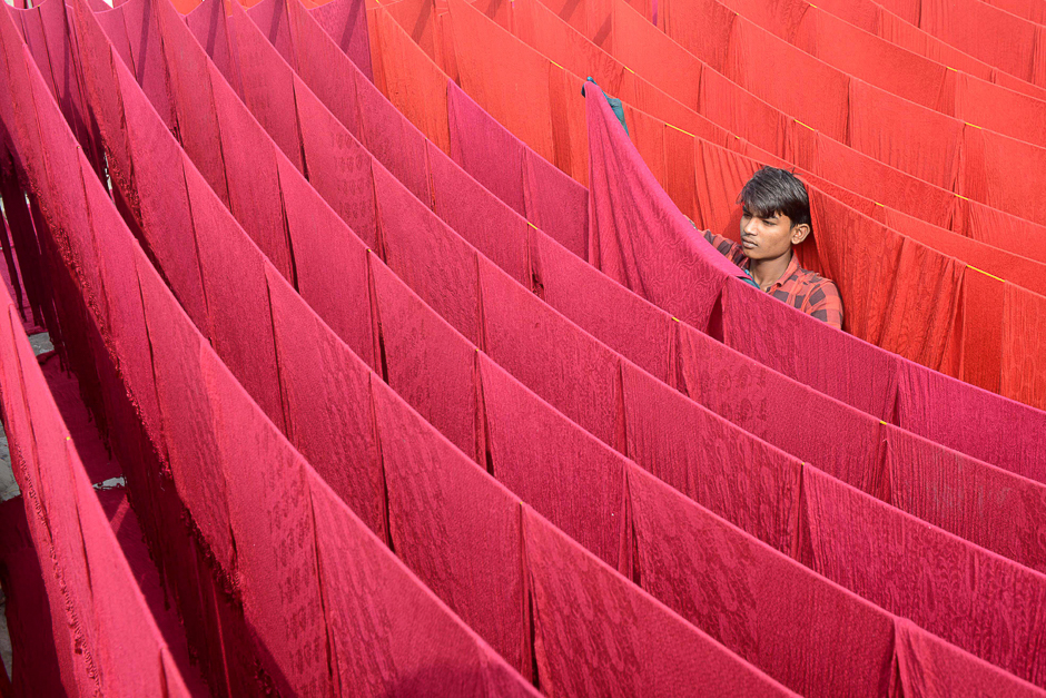 Indian artisan dries stoles after dyeing in Amritsar. PHOTO: AFP