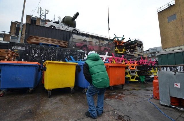 Pete, a homeless man working as a tourist guide for social enterprise Unseen Tours, points at a street-art installation near Brick Lane, London, Britain on November 11, 2017. 
PHOTO: REUTERS