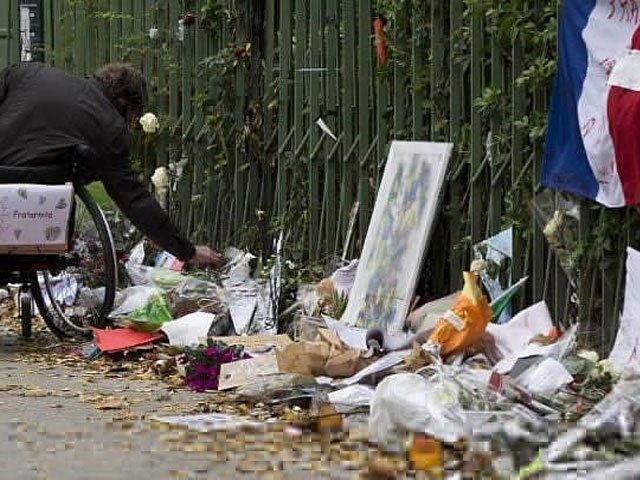A man in a wheelchair pays tribute to the victims of the November 13 terror attacks at a makeshift memorial near the Bataclan concert hall in Paris on December 10, 2015. PHOTO: AFP/FILE