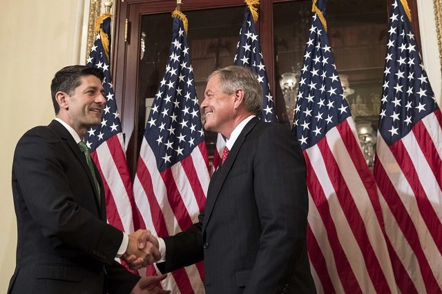 In this file photo taken on June 25, 2017, (L to R) Speaker of the House Paul Ryan shakes hands with Representative-elect Ralph Norman (R-SC) during in a ceremonial swearing-in on Capitol Hill in Washington, DC.  A US congressman said he pulled out a loaded Smith & Wesson pistol during a meeting with gun control activists on April 6, 2018 in a bid to prove that firearms are not responsible for violence.
PHOTO:AFP