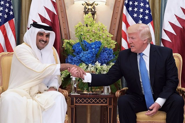 US President Donald Trump (R) and Qatar's Emir Sheikh Tamim Bin Hamad Al-Thani 
PHOTO:AFP