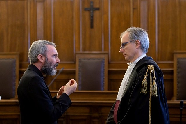 Father Carlo Alberto Capella, a Catholic priest sentenced to five years in jail for possessing child pornography, talks with his lawyer during a trial at the Vatican June 23, 2018. PHOTO: REUTERS