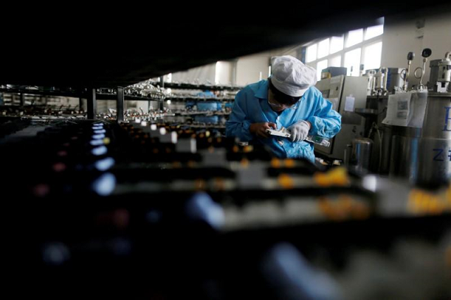 A labourer works inside an electronics factory in Qingdao, Shandong province, China. PHOTO: REUTERS