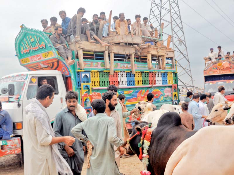 An overloaded bus leaves a bus terminal in Islamabad, while Seventh Avenue is deserted a day ahead of Eidul Azha. PHOTO: EXPRESS