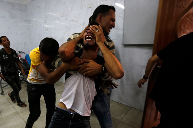 A relative of the two Palestinian men, who were killed in an Israeli air strike the night before, mourns in the morgue upon identifying the bodies in Khan Yunis in the southern Gaza Strip on September 18, 2018. PHOTO: AFP