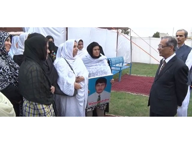 Justice Nisar interacts with APS martyrs' families. SCREENGRAB
