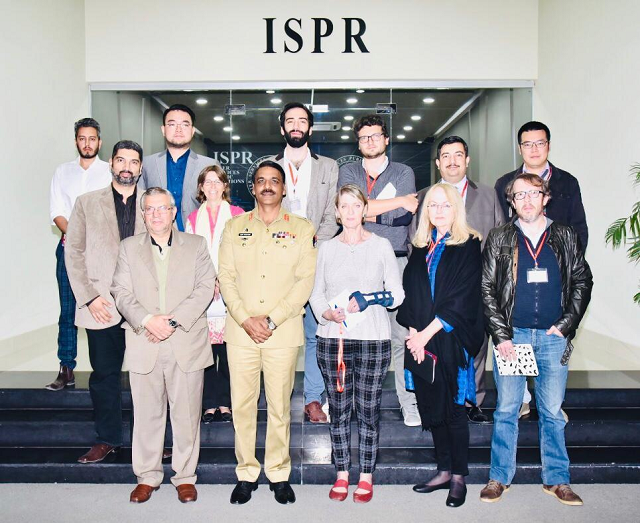 Maj Gen Asif Ghafoor with foreign media representatives outside the ISPR office. PHOTO: ISPR