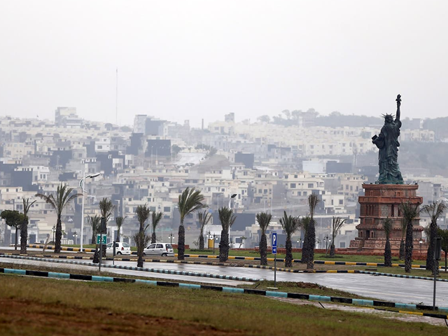 A replica of the Statue of Liberty stands on a hill overlooking the construction of new homes in Bahria Town on the outskirts of Islamabad. Photo: Reuters