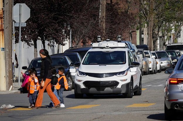 Children pass by a self-driving Chevy Bolt EV car during a media event by Cruise, GM’s autonomous car unit, in San Francisco, California, US on November 28, 2017.
PHOTO: REUTERS