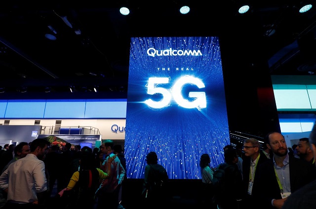 People walk by a video display promoting 5G connectivity at the Qualcomm booth during the 2019 CES in Las Vegas, Nevada, US January 8, 2019.
PHOTO: REUTERS