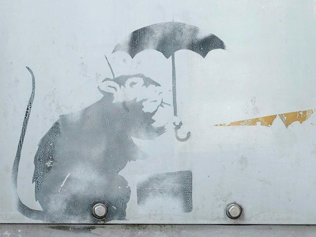 Curious Tokyoites, tourists and art lovers are flocking to see the work depicting a rat holding an umbrella. PHOTO: AFP
