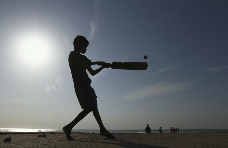 A boy plays cricket. PHOTO: REUTERS
