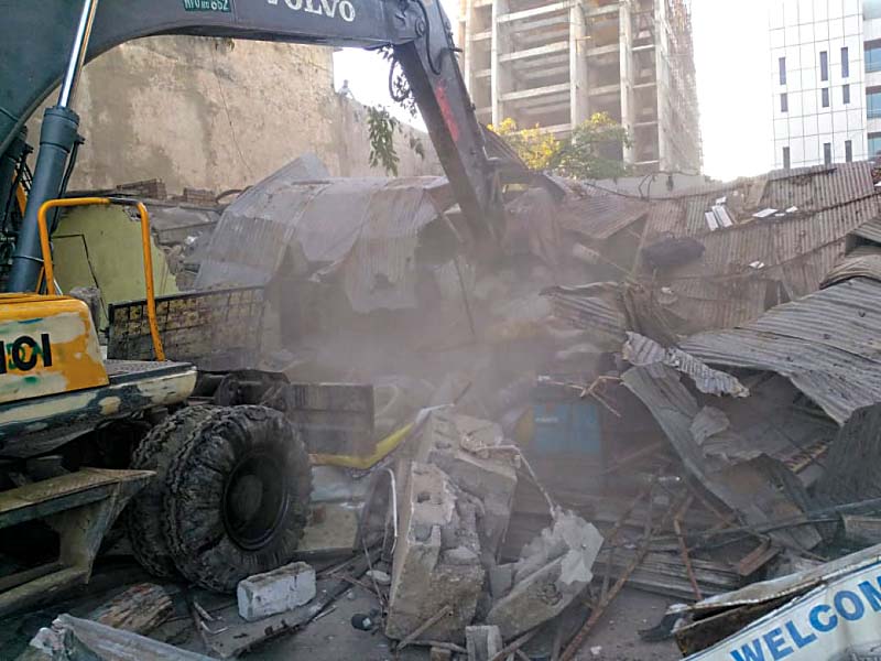 An excavator tears down illegal construction. PHOTO: EXPRESS