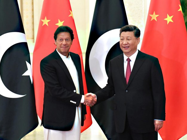 Prime Minister Imran Khan shakes hands with President Xi Jinping in Beijing before a meeting at the Great Hall of the People. PHOTO: REUTERS