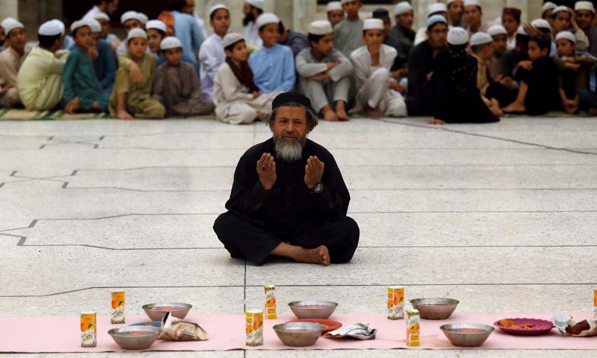 A man prays before breaking his fast during the fasting month of Ramadan in Peshawar, Pakistan, May 6, 2019. PHOTO: REUTERS