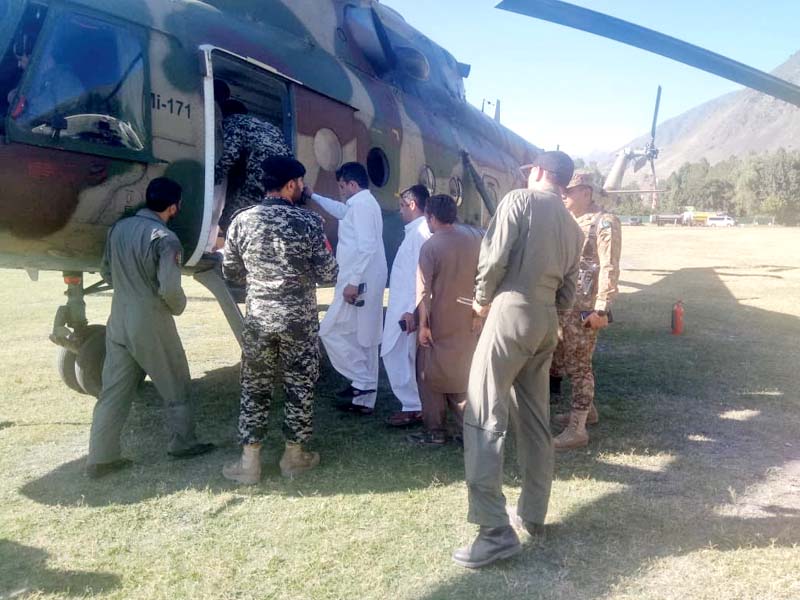 Army personnel evacuate stranded people in a helicopter in Chitral. PHOTO: EXPRESS