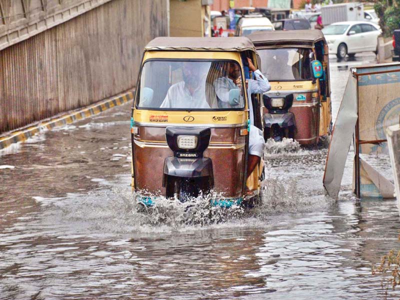 Commuters face difficulty plying on the road in front of the National Institute of Child Health due to the overflowing sewerage water. The same road houses some of the largest public hospitals of the province. Several areas of the city have been affected by overflowing sewerage water after the recent rains. PHOTO: APP