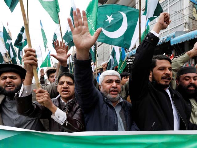People raise their hands as they chant slogans to show solidarity with Pakistan Armed Forces at a rally in Peshawar. PHOTO: REUTERS