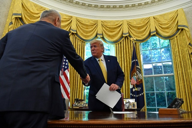 Vice Premier of the People's Republic of China Liu He shakes hands with US President Donald Trump. PHOTO: AFP