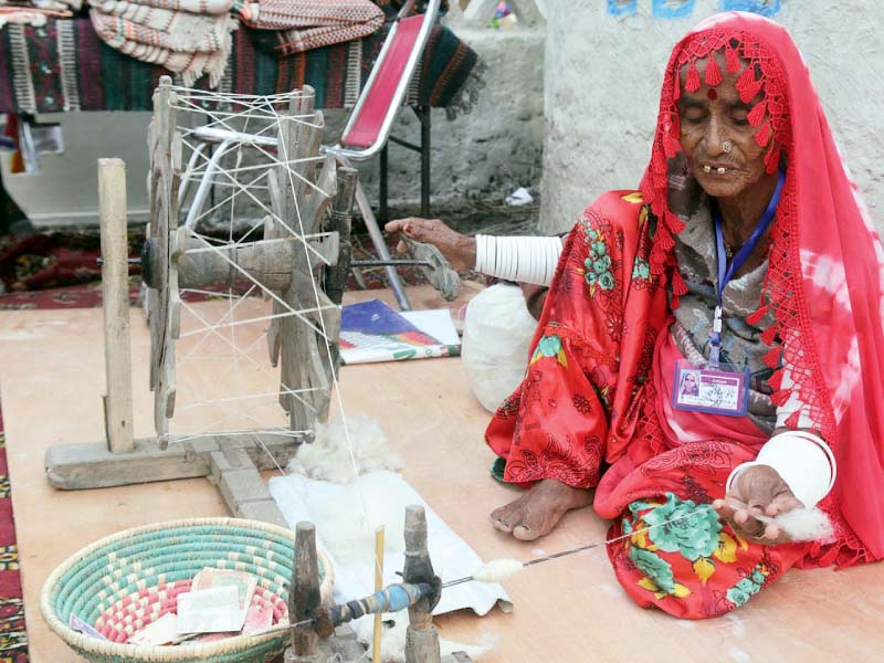 An elderly woman from Sindh in her work at Lok Mela. PHOTO: INP