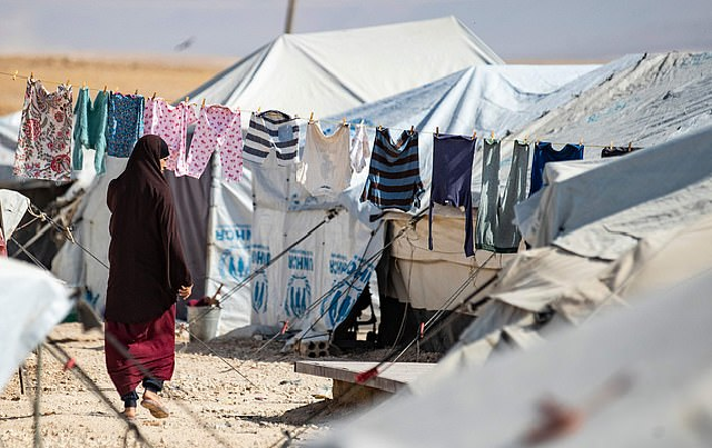 This photo shows a woman walking among tents at the Kurdish-run al-Hol camp for the displaced where families of Islamic State (IS) foreign fighters are held. PHOTO: AFP