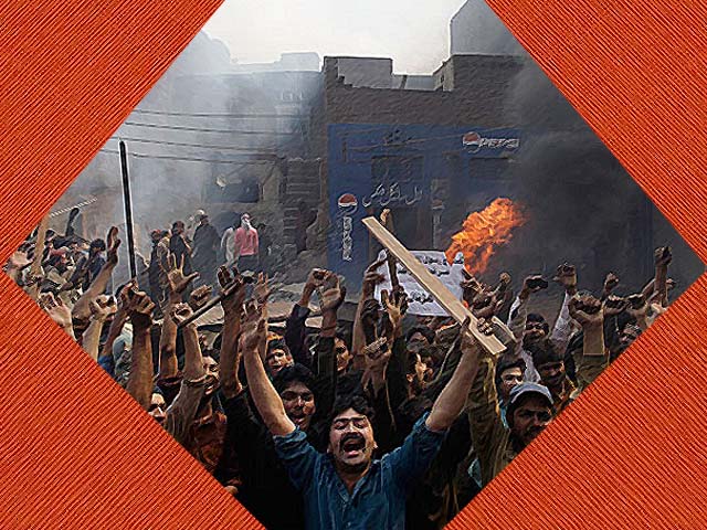 An angry mob reacts after burning Christian houses in Lahore. PHOTO: AFP