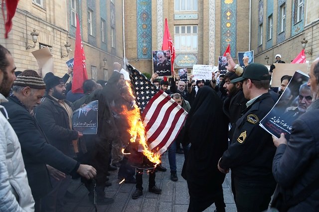 Demonstrators burn the U.S. flag as they gather to show their anger of Iran's Foreign Minister Javad Zarif for any negotiation with the US in front of the foreign ministry building in Tehran, Iran. PHOTO: REUTERS