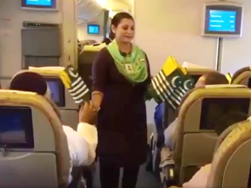 Cabin crew members announce special message, hand out Kashmiri flags to passengers in flight. SCREENGRAB: TWITTER/@PIAofficial