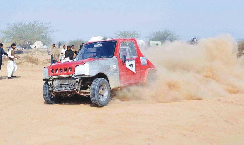 A contestant drives through sand during the Cholistan jeep rally . 
PHOTO: INP