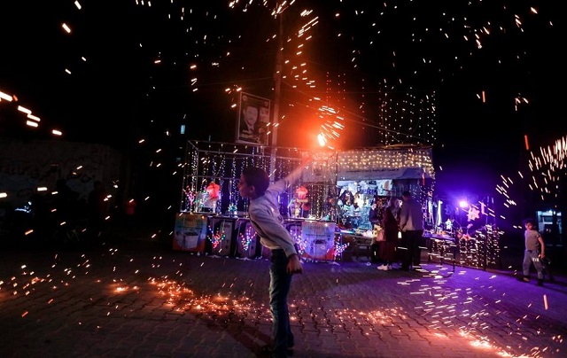 A Palestinian boy waves a homemade sparkler firework as he celebrates ahead of the holy fasting month, amid concerns about the spread of the coronavirus disease (Covid-19),in the southern Gaza Strip. PHOTO: AFP/FILE