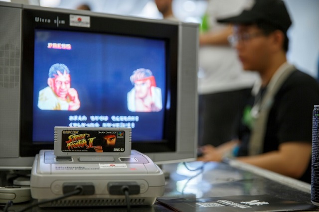 A group of Japanese retro gaming fans is offering 100 Super Nintendo consoles, similar to the one pictured here, to cooped-up kids. PHOTO: AFP