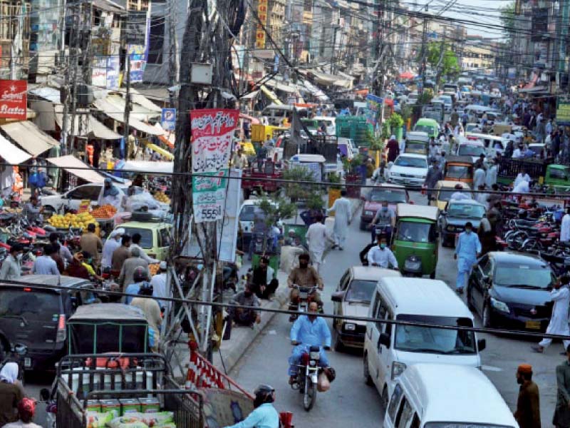 Vehicles are caught in traffic jam due to the rush of buyers at a market in Rawalpindi ahead of Eid. PHOTO: AGHA MEHROZ