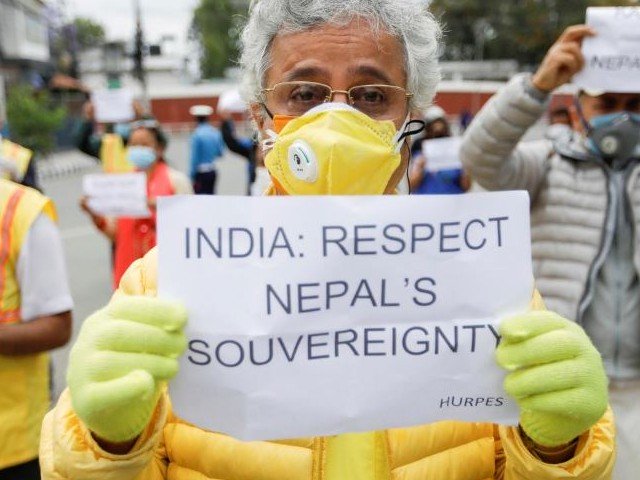 Activists affiliated with 'Human Rights and Peace Society Nepal' holding placards protest against the alleged encroachment of Nepal's border by India in the far west of Nepal, near the Indian Embassy in Kathmandu, Nepal May 12, 2020. PHOTO: REUTERS/FILE